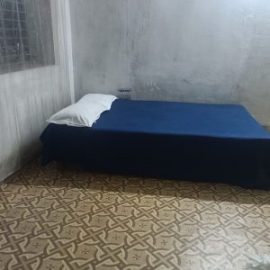 Left view of dormitory beds at Hotel Kalzug, Katihar – affordable stay for men with comfortable sleeping arrangements.